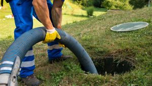 Emptying household septic tank. Cleaning sludge from septic system